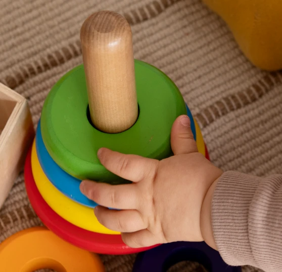 high-angle-kid-playing-with-colorful-toys